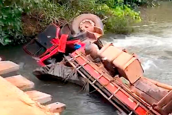 Caminhão carregado com sal cai de ponte e motorista morre preso às ferragens